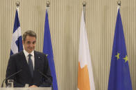 This image provided from Cyprus' press and information office, Greece's Prime minister Kyriakos Mitsotakis is seen during a press conference after a meeting with Cyprus President Nicos Anastasiades at the presidential palace in capital Nicosia, Cyprus, on Monday, Feb. 8, 2021. Mitsotakis is in Cyprus for one-day official visit. (Stavros Ioannides, PIO via AP)