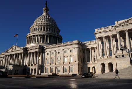 FILE PHOTO: People walk by the U.S. Capitol building in Washington, U.S., February 8, 2018. REUTERS/ Leah Millis