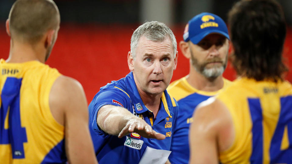 Pictured here, West Coast coach Adam Simpson addresses his players during an AFL match.