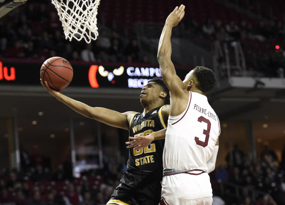 Wichita State's Grant Sherfield (52) drives to the basket past Temple's Josh Pierre-Louis (3) during the first half of an NCAA college basketball game Wednesday, Jan. 15, 2020, in Philadelphia. (AP Photo/Michael Perez)