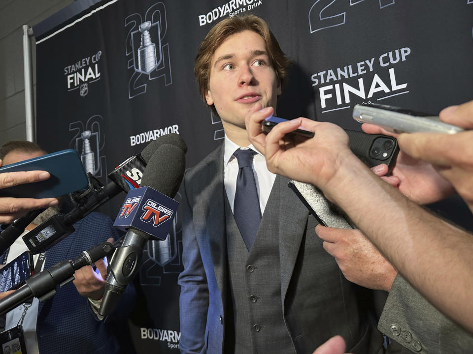 Macklin Celebrini, the expected No. 1 pick in the NHL draft to the San Jose Sharks, speaks with reporters prior to Game 2 of the Stanley Cup Final at Amerant Bank Arena in Sunrise, Florida, Monday, June 10, 2024. (AP Photo/Stephen Whyno)