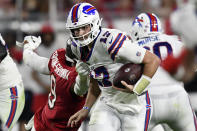 Buffalo Bills quarterback Josh Allen (17) slips a tackle by Tampa Bay Buccaneers linebacker Joe Tryon-Shoyinka (9) on an 18-yard touchdown run during the second half of an NFL football game Sunday, Dec. 12, 2021, in Tampa, Fla. (AP Photo/Jason Behnken)