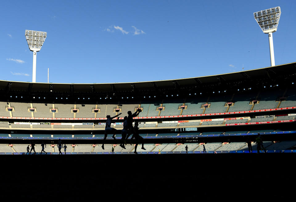 Players compete for a mark during the round 23 AFL match between Essendon Bombers and Collingwood Magpies Giants at Melbourne Cricket Ground on August 22, 2021 in Melbourne, Australia