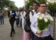 People wait in a queue outside the NCPA to pay their respects to Ratan Tata, in Mumbai