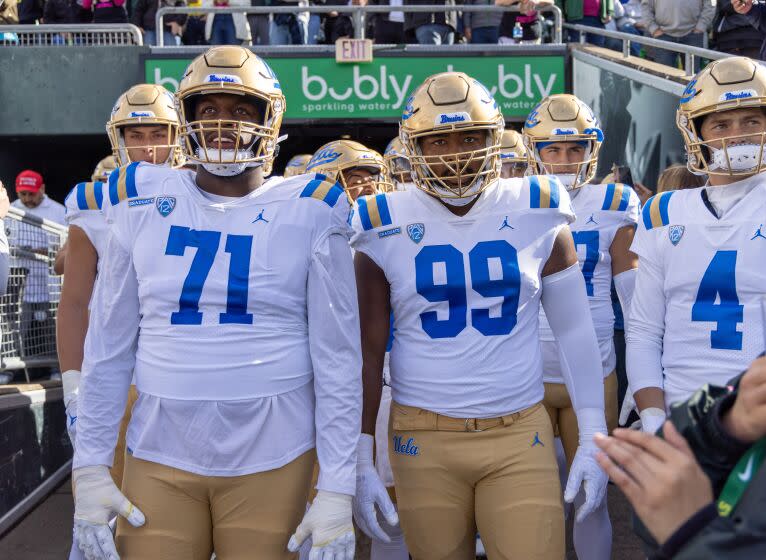 EUGENE, OR - OCTOBER 22: Offensive lineman Raiqwon O'Neal #71 of the UCLA Bruins and defensive lineman Jacob Sykes #99 of the UCLA Bruins lead the team on the field against the Oregon Ducks at Autzen Stadium on October 22, 2022 in Eugene, Oregon. (Photo by Tom Hauck/Getty Images)