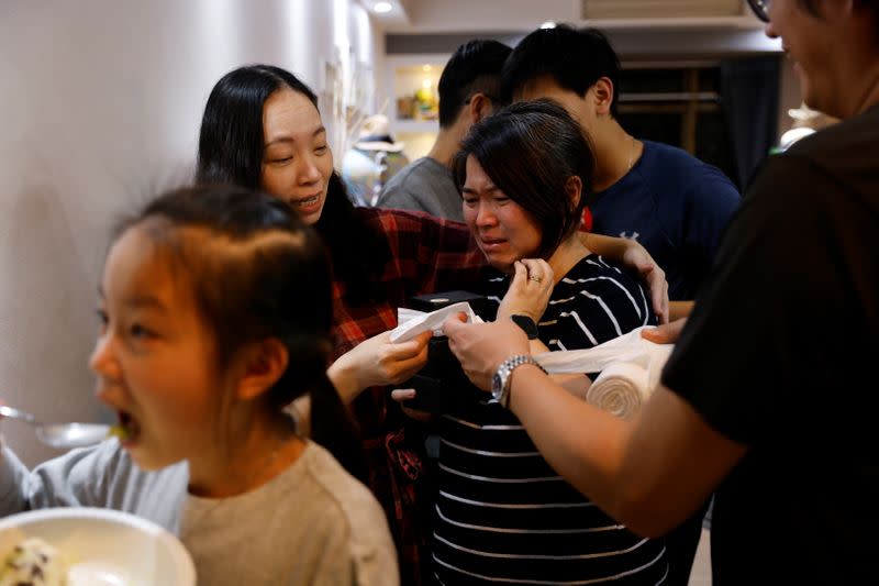 The Wider Image: Leaving Hong Kong: A family makes a wrenching decision