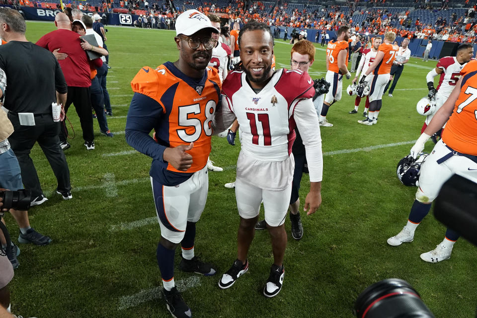 FILE - In this Aug. 29, 2019, file photo, Denver Broncos outside linebacker Von Miller (58) greets Arizona Cardinals wide receiver Larry Fitzgerald (11) after an NFL preseason football game in Denver. The NFL will cut its preseason in half and push back the start of exhibition play so teams have more time to train following an all virtual offseason made necessary by the coronavirus pandemic, a person with knowledge of the decision told The Associated Press. The person spoke on condition of anonymity because the league hasn’t announced that the preseason will be cut from four games to two. (AP Photo/Jack Dempsey, File)