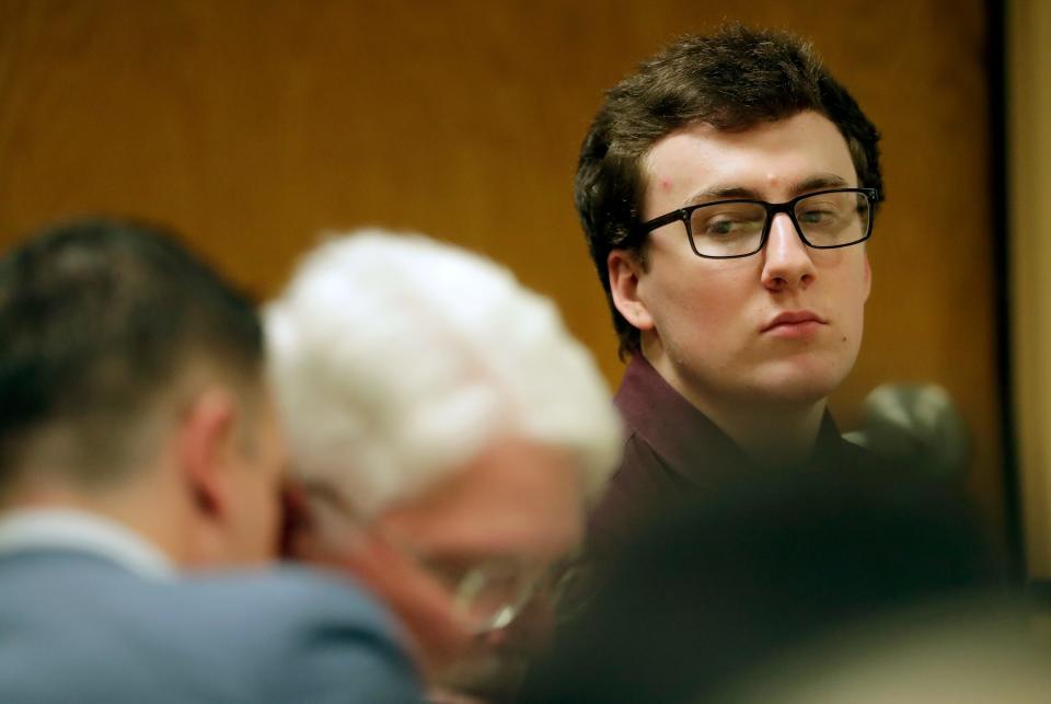 Grant Fuhrman, right, looks on as his lawyers confer in court Jan. 24 at the Winnebago County Courthouse in Oshkosh. Fuhrman, 20, is charged with attempted first-degree intentional homicide for the 2019 stabbing of an Oshkosh West school resource officer, Michael Wissink. At the time of the incident, Fuhrman was a 16-year-old junior at Oshkosh West High School.