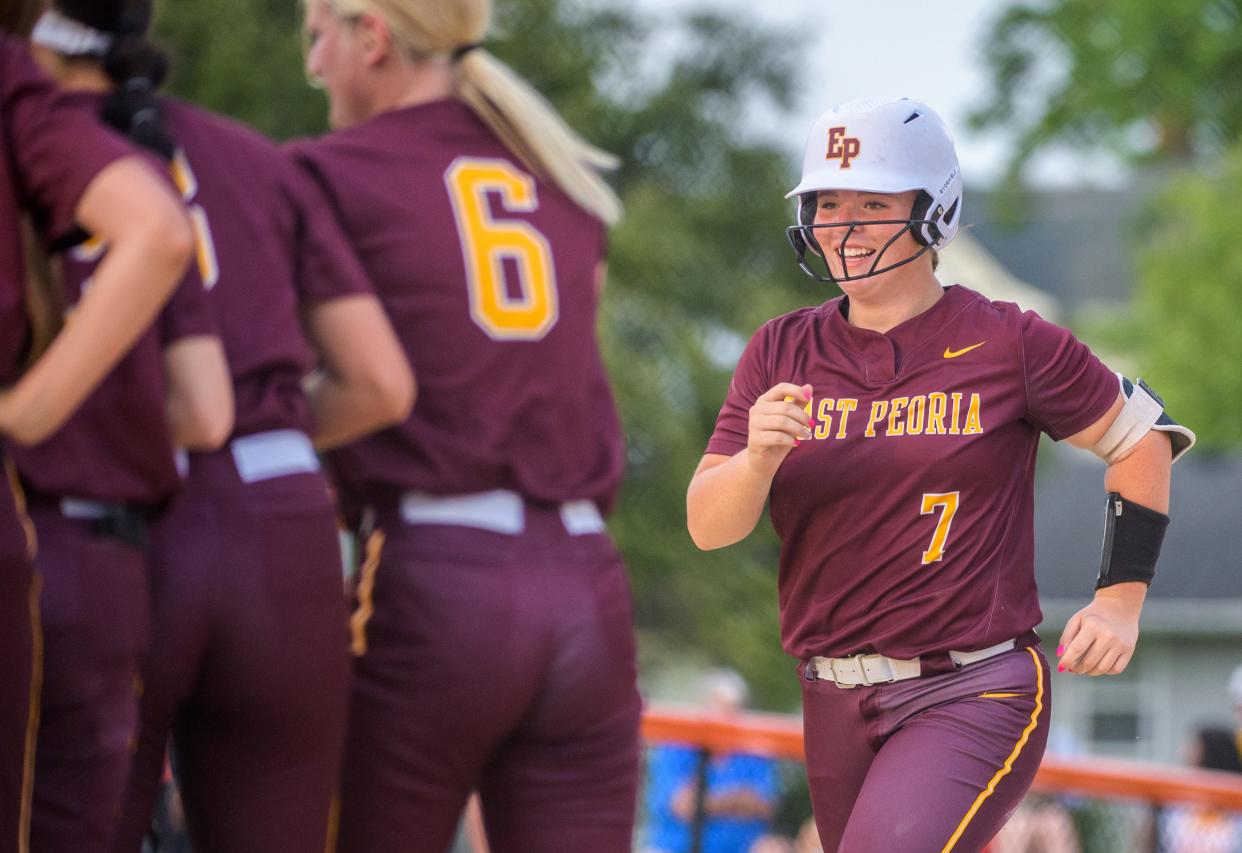 East Peoria's Gracie Luna (7) runs to her teammates at home plate after hitting a home run last season during a sectional semifinal. Luna has again switched positions and it fueling the state-ranked Raiders on the diamond this spring.