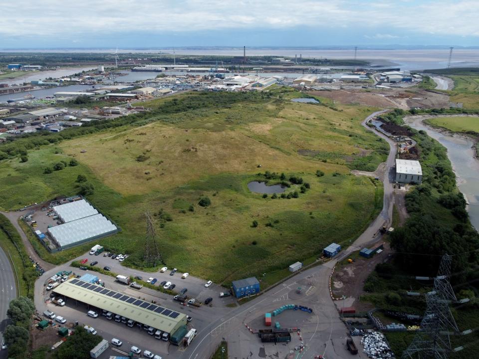 An arial shot of a landfill, with grass turf over it.