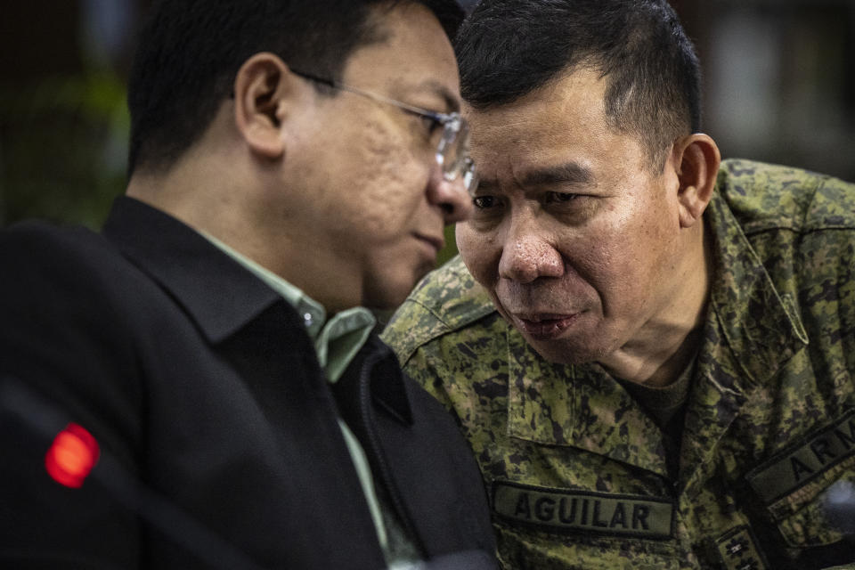 Col. Medel Aguilar, right, spokesperson for the Armed Forces of the Philippines, whispers to Jonathan Malaya, spokesperson for the National Security Council as they take part in a press conference on the recent actions by the Chinese Coast Guard against Philippine vessels in the South China Sea, at the Philippine Department of Foreign Affairs in Manila, Philippines on Monday, Aug. 7, 2023. The Philippine government summoned the Chinese ambassador on Monday to convey a diplomatic protest over the Chinese coast guard's use of a water cannon against a Filipino supply boat in the disputed South China Sea, a Philippine official said. (Ezra Acayan/Pool Photo via AP)