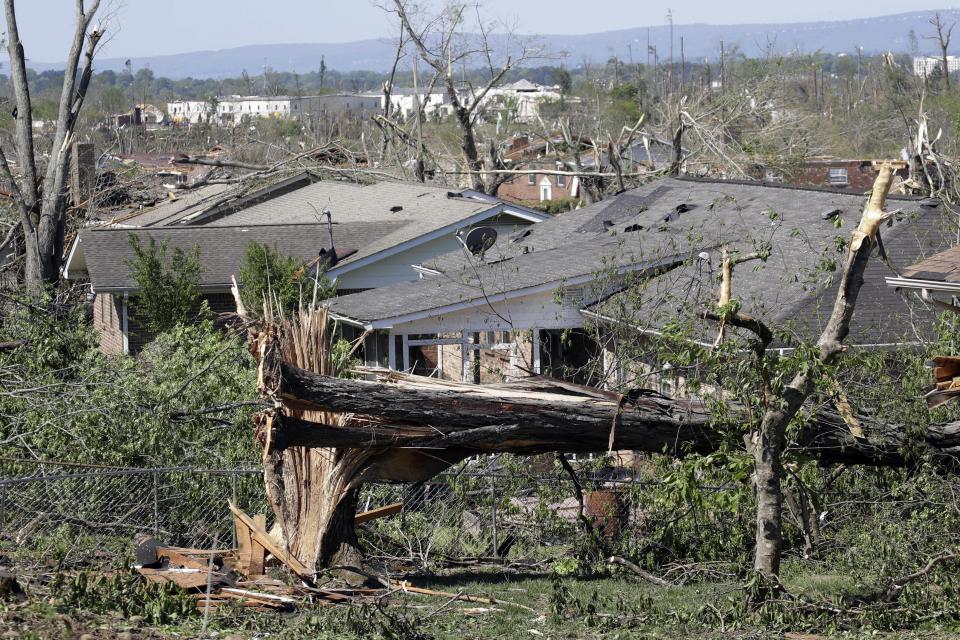 A fallen tree lies in a neighborhood of damaged homes Tuesday, April 14, 2020, in Chattanooga, Tenn. Tornadoes went through the area Sunday, April 12. (AP Photo/Mark Humphrey)
