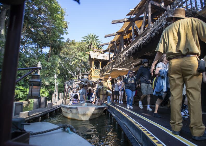 Anaheim, CA - July 09: Passengers disembark the Jungle Cruise ride at Adventureland, Disneyland in Anaheim, CA, on Friday, July 9, 2021. The official reopening of Jungle Cruise will be on July 16, 2021, with new adventures, an expanded storyline and more humor as skippers take guests on a tongue-in-cheek journey along some of the most remote rivers around the world at Disneyland. What's new: The expanded backstory centers around Alberta Falls, the granddaughter of the world-renowned Dr. Albert Falls, who is now proprietor of the Jungle Navigation Company Ltd. New scenes include: A safari of explorers from around the world finds itself up a tree after the journey goes awry. Chimpanzees have taken over the expedition's wrecked boat. A Lost & Found location has turned into a Gift Shop run by Alberta's longtime friend, Trader Sam. (Allen J. Schaben / Los Angeles Times)