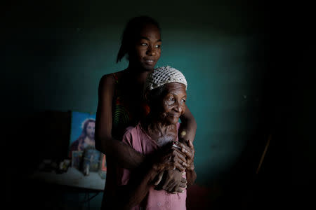 FILE PHOTO: Aidalis Guanipa, 25, a kidney disease patient, poses for a photo with her 83-year-old grandmother, while they wait for the electricity to return, at her house during a blackout in La Concepcion, Venezuela, April 12, 2019. REUTERS/Ueslei Marcelino