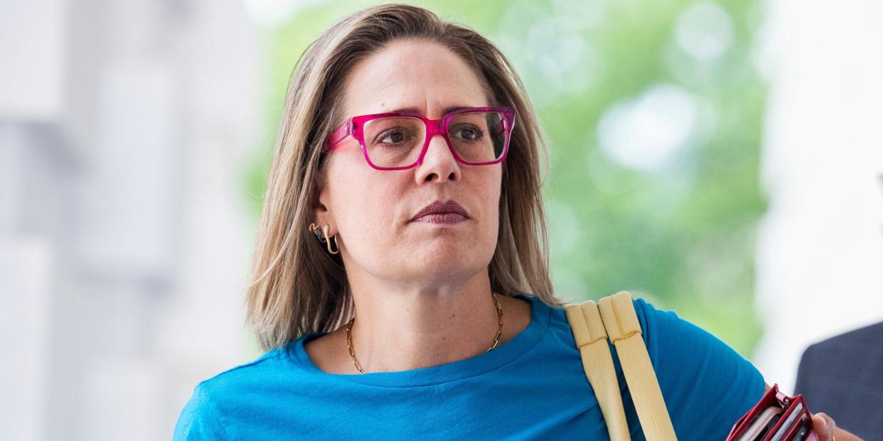 Sinema walking with a pink phone case and tan bag