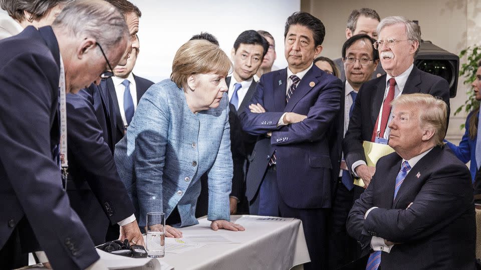 Former German Chancellor Angela Merkel (center) deliberates with Donald Trump (seated far right) on the sidelines of the official agenda on the second day of the G7 summit on June 9, 2018 in Charlevoix, Canada. - Jesco Denzel/Bundesregierung/Getty Images