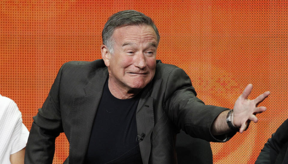 Cast member Robin Williams gestures at a panel for the television series 