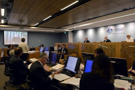 Senior Counsel Assisting Gail Furness (L) stands in front of a screen displaying Australian Cardinal George Pell as he appears via video link from a hotel in Rome, Italy to testify at the Australia's Royal Commission into Institutional Response to Child Sexual Abuse in Sydney, Australia, February 29, 2016. REUTERS/Jeremy Piper-Oculi/Handout via Reuters