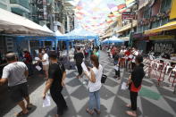 People wait in line for COVID-19 swab tests in Khaosan Road in Bangkok, Thailand Wednesday, April 14, 2021. Thailand recorded more than 1,000 COVID-19 infections on Wednesday, setting a daily record and adding pressure on the government to do more to control the country's spiking transmission rates. (AP Photo/Somchai Chanjirakitti)