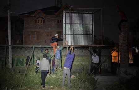 The Wider Image: Barricades and books in restive Kashmir neighbourhood