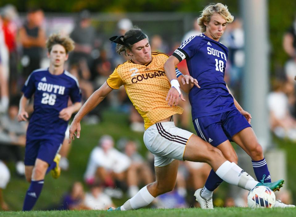 Bloomington North’s Jackson Jent (2) attempts to tackle the ball away from Bloomington South’s Joe DeGiorgio (10) during the North-South boys’ soccer match at South on Thursday, September 14, 2023.