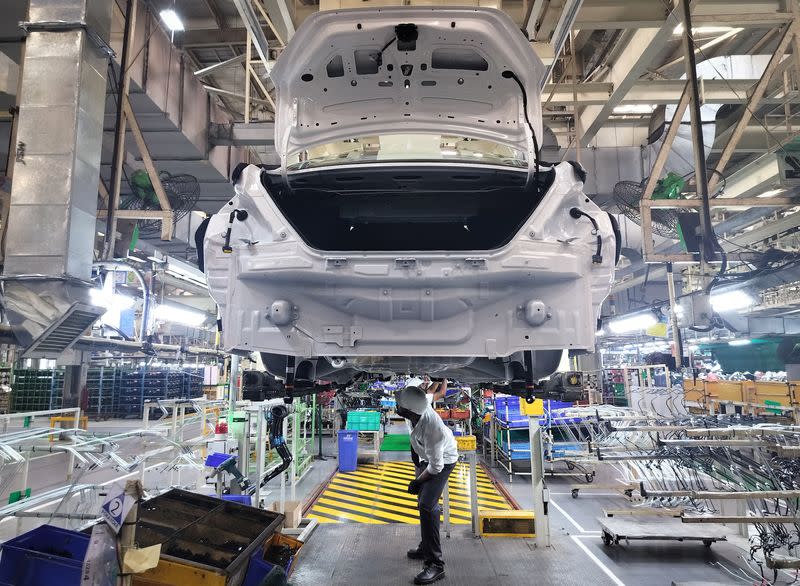 Employees work at the manufacturing plant of Renault Nissan Automotive India in Oragadam