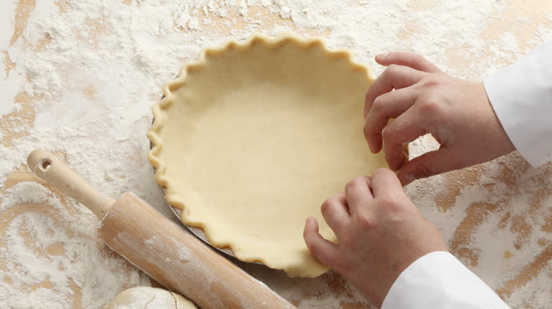 Person pinching pie dough