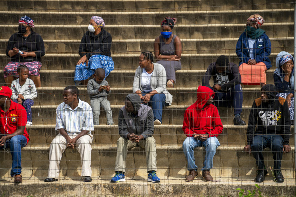 Residents from the Alexandra township in Johannesburg gather in a stadium to be tested for COVID-19 Monday, April 26, 2020. South Africa will began a phased easing of its strict lockdown measures on May 1, although its confirmed cases of coronavirus continue to increase. (AP Photo/Jerome Delay)