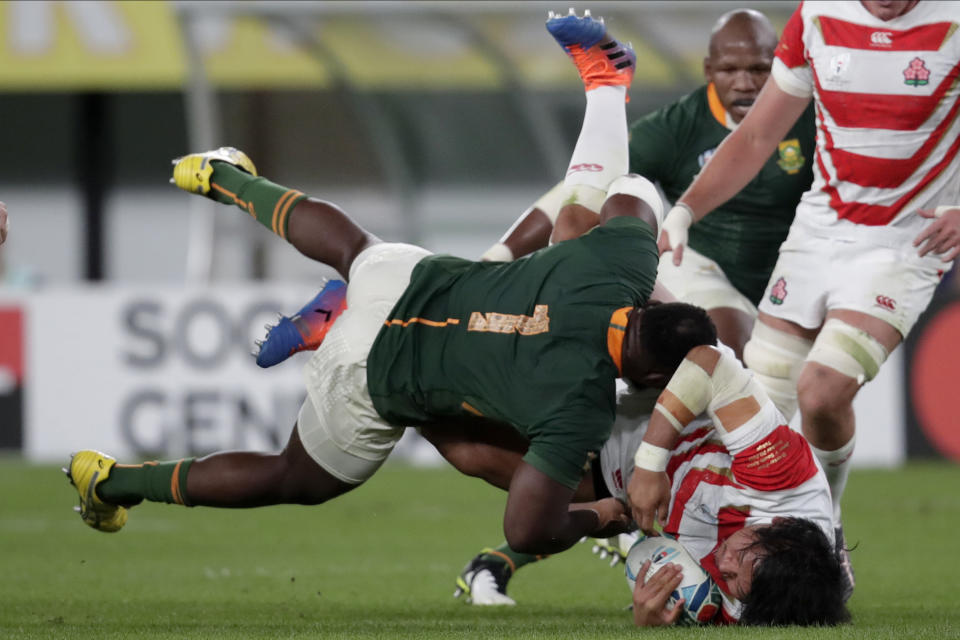 South Africa's Tendai Mtawarira tackles Japan's Keita Inagaki during the Rugby World Cup quarterfinal match at Tokyo Stadium between Japan and South Africa in Tokyo, Japan, Sunday, Oct. 20, 2019. (AP Photo/Jae C. Hong)