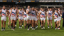 Adelaide players in tears as they leave the field.