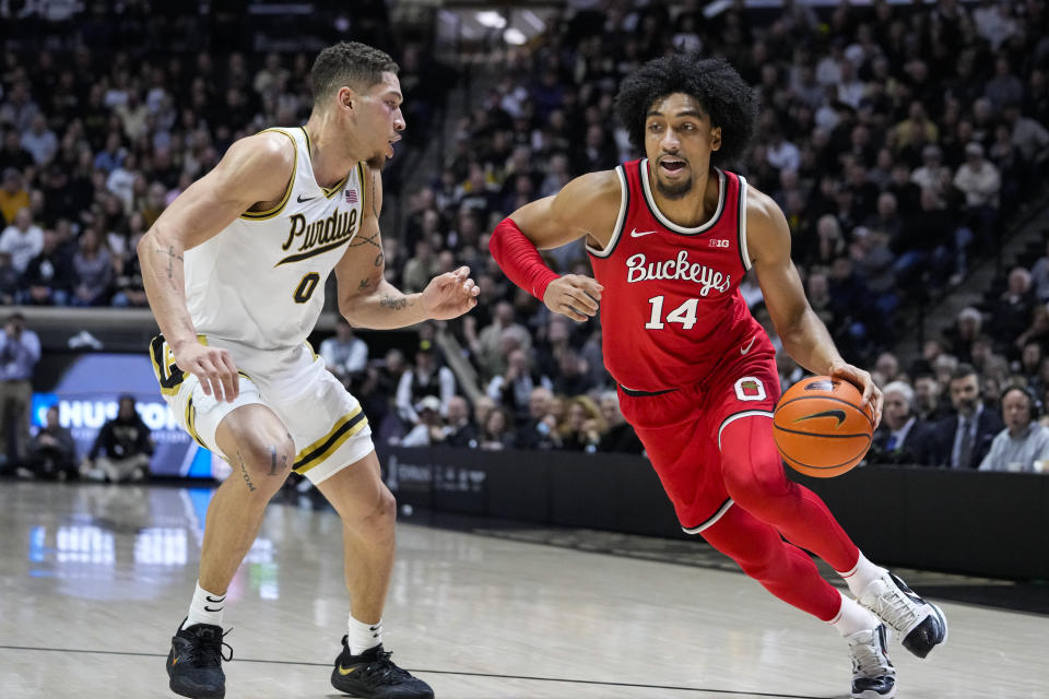 Ohio State forward Justice Sueing (14) drives on Purdue forward Mason Gillis (0) in the first half of an NCAA college basketball game in West Lafayette, Ind., Sunday, Feb. 19, 2023. (AP Photo/Michael Conroy)