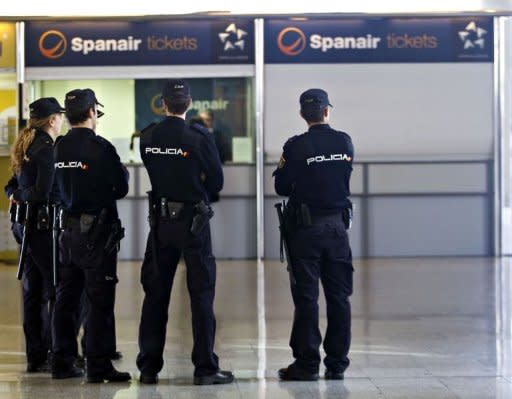 Spanish policemen stand in front of a Spanair office at the Son Sant Joan airport in Palma de Mallorca. Spanair filed for voluntary bankruptcy Monday, officials said, three days after abruptly stopping all flights and stranding tens of thousands of passengers