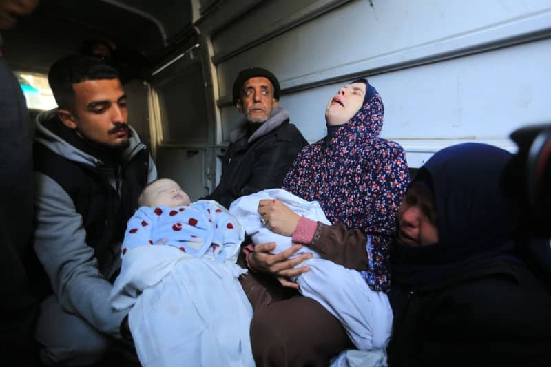 Palestinians mourn their relatives and loved ones who were killed in an Israeli bombing on the city of Rafah, on the home of the Abu Anza family. Mohammed Talatene/dpa