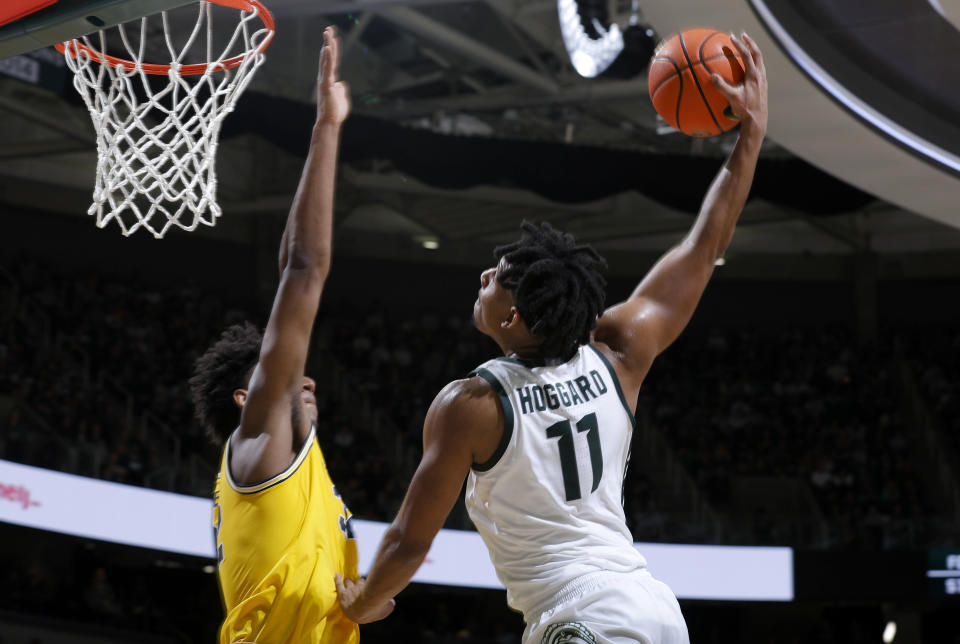 Michigan State guard A.J. Hoggard (11) goes up for a shot against Michigan forward Tarris Reed Jr. during the second half of an NCAA college basketball game, Tuesday, Jan. 30, 2024, in East Lansing, Mich. (AP Photo/Al Goldis)