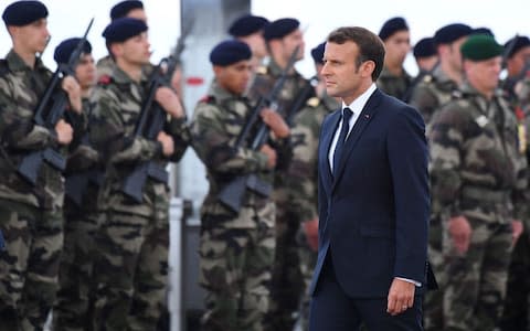 French President Emmanuel Macron inspects troops in Normandy - Credit: Damien MEYER / AFP