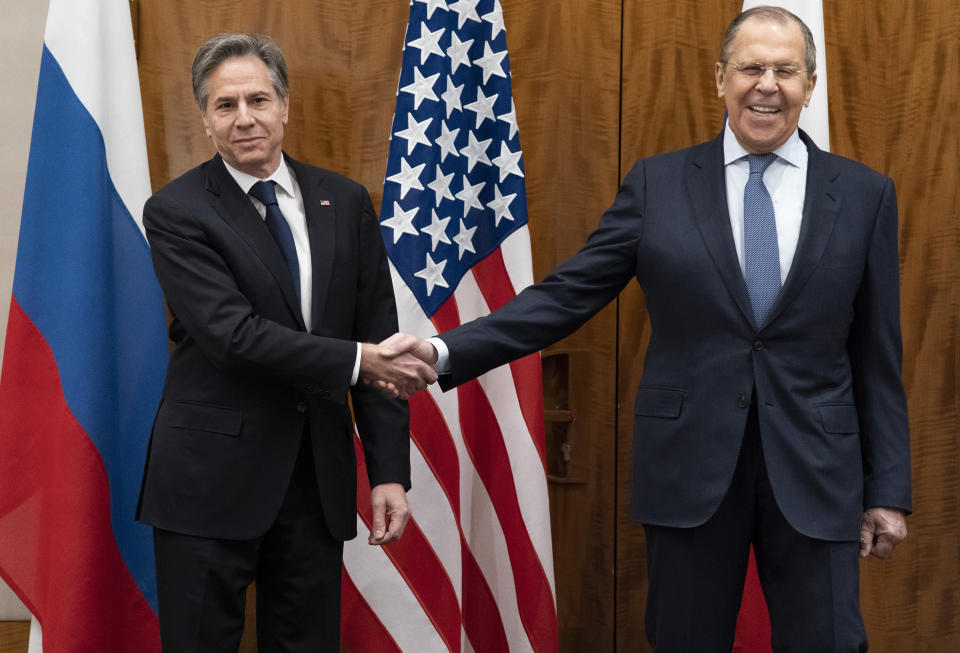 US Secretary of State Antony Blinken, left, shakes hands with Russian Foreign Minister Sergey Lavrov before their meeting, Friday, Jan. 21, 2022, in Geneva, Switzerland. (AP Photo/Alex Brandon, Pool)