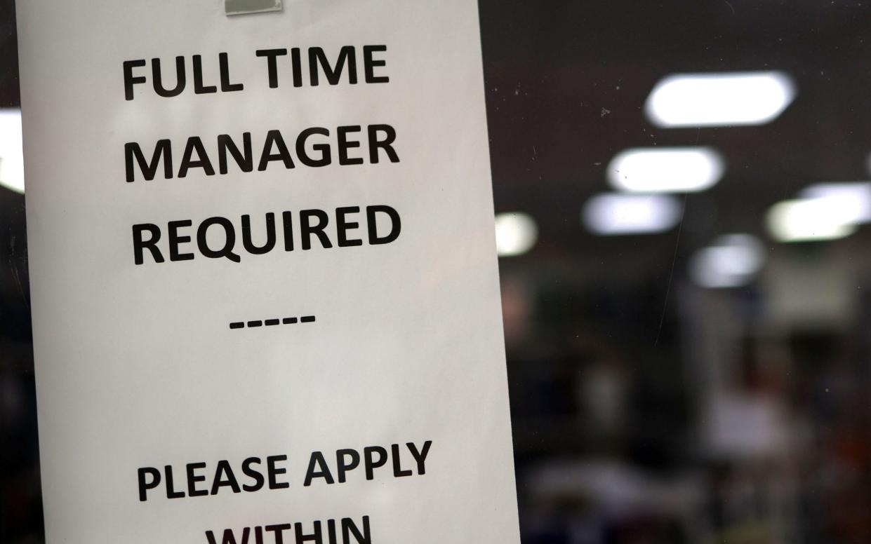 A job is advertised in a store window in London, Britain, 16 January 2024