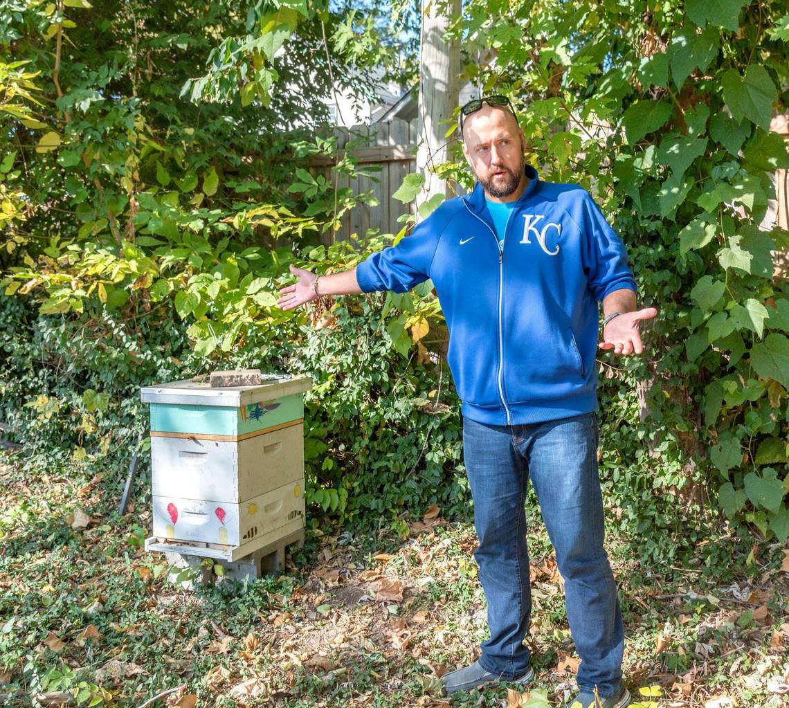 Beekeeper Joshua Henry with one of the four hives he manages on the Young Family Farm. He sells jars of honey at the farm.