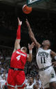 Ohio State's Duane Washington Jr., left, shoots against Michigan State's Aaron Henry (11) during the first half of an NCAA college basketball game, Sunday, March 8, 2020, in East Lansing, Mich. (AP Photo/Al Goldis)