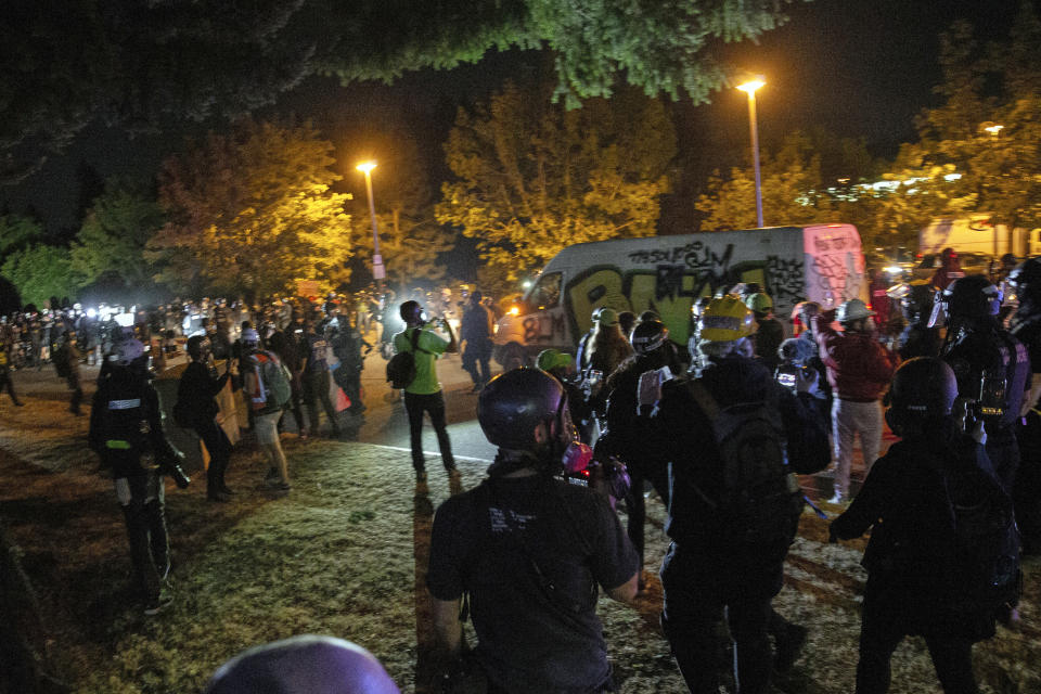 Demonstrators gather at Floyd Light City Park Thursday, Aug. 6, 2020 in Portland, Ore. State legislatures across the U.S. are pushing an array of policing reforms after the demonstrations related to the death of George Floyd last spring, from banning chokeholds to making it easier to hold officers legally accountable for their actions. (Mark Graves/The Oregonian via AP)