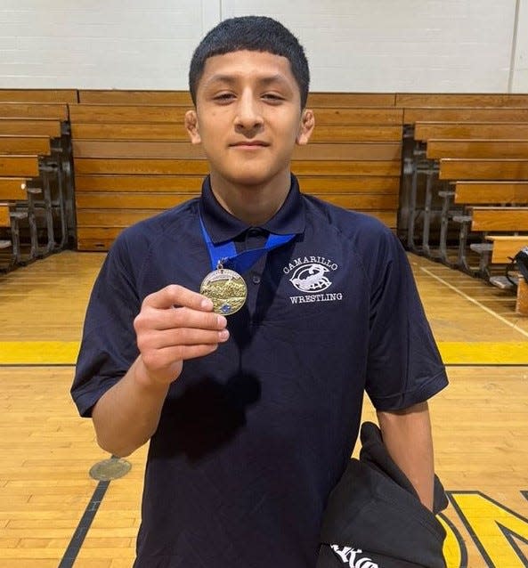 Camarillo High's Joshua Requena poses with his first-place medal after winning the 126-pound championship at the CIF-Southern Section Eastern Division Boys Wrestling Individuals on Saturday at Capistrano Valley High.