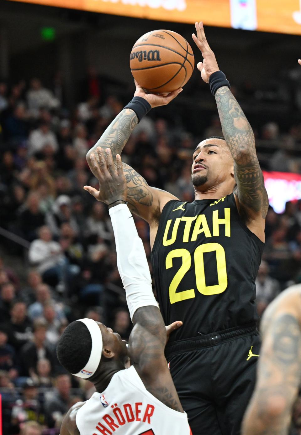 Utah Jazz forward John Collins (20) shoots over Toronto Raptors guard Dennis Schroder (17) as the Jazz and Raptors play at the Delta Center in Salt Lake City on Friday, Jan. 12, 2024. Utah won 145-113. | Scott G Winterton, Deseret News