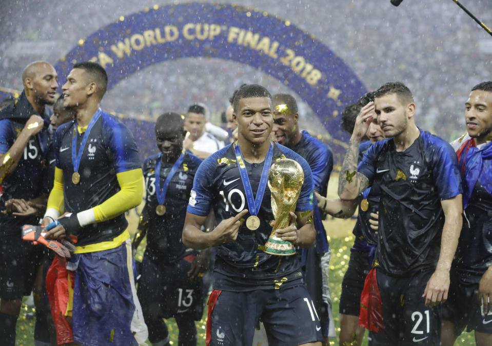 France's Kylian Mbappe celebrates with the trophy after the final match between France and Croatia at the 2018 soccer World Cup in the Luzhniki Stadium in Moscow, Russia, Sunday, July 15, 2018. France won the final 4-2. (AP Photo/Matthias Schrader)