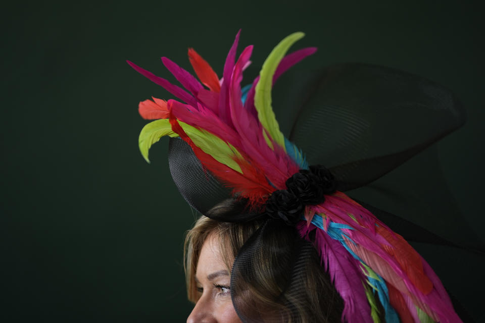 A race fan walks through the grounds of Churchill Downs before the 150th running of the Kentucky Derby horse race Saturday, May 4, 2024, in Louisville, Ky. (AP Photo/Charlie Riedel)