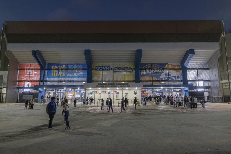 Fans arrive at the Ruben Rodríguez Coliseum to watch a basketball game between the Bayamon Vaqueros and the Guaynabo Mets, in Bayamón, Puerto Rico, Monday, July 1, 2024. Puerto Rico’s professional basketball league is experiencing a renaissance thanks to reggaeton stars like Bad Bunny, Ozuna and Anuel AA, who are stepping into the financial game, buying local teams and helping to stack up a loyal fan base. (AP Photo/Alejandro Granadillo)