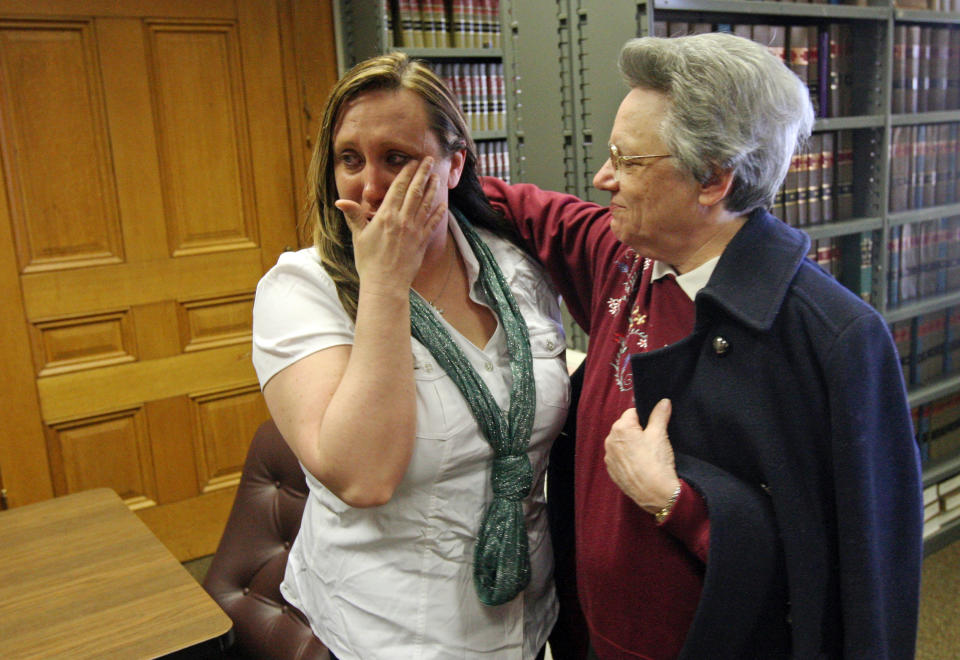 Kelli Jo Griffin, left, Montrose, Iowa, wipes away tears as she is embraced by Sister Peggy from the Holy Family Catholic Church of Fort Madison, following her not guilty verdict Thursday March 20, 2014 in Keokuk, Iowa. The former drug offender, who believed her voting rights had been restored when she cast a ballot last year, was acquitted of perjury - a public rebuke of Iowa's two-year investigation into voter fraud. It was the first trial stemming from the state's voter fraud investigation championed by Secretary of State Matt Schultz, a Republican. (AP Photo/The Hawk Eye, John Gaines)