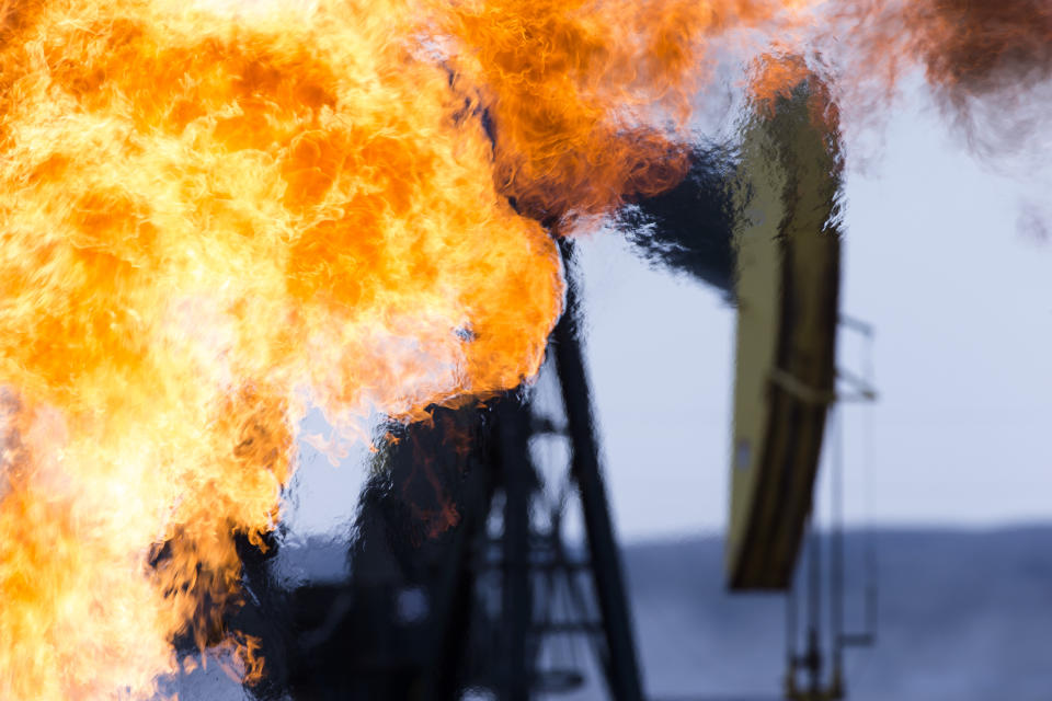 A methane gas flare and pump jack at an oil well in the Bakken Oil Fields, North Dakota. (Photo: Richard Hamilton Smith via Getty Images)