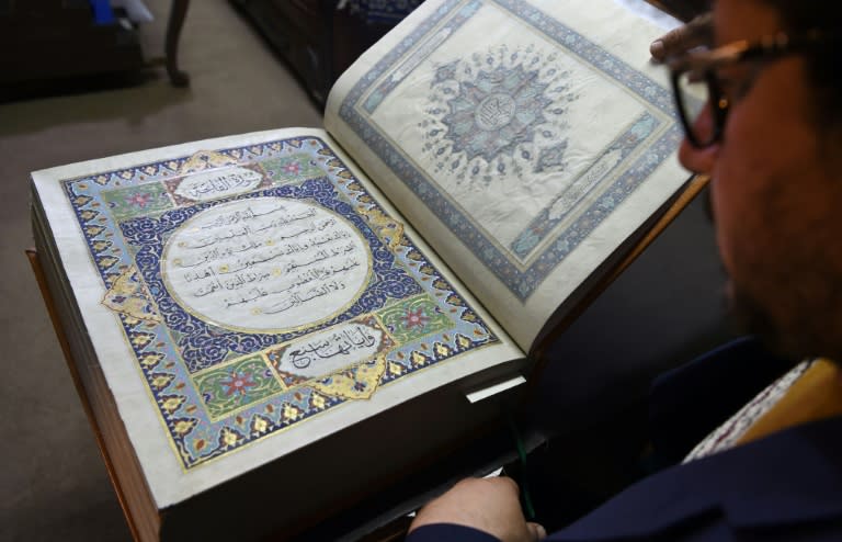 Afghan master miniature artist Mohammad Tamim Sahibzada shows a Koran handmade with silk fabric at the Turquoise Mountain Foundation in Mourad Khani, in the old city section of Kabul