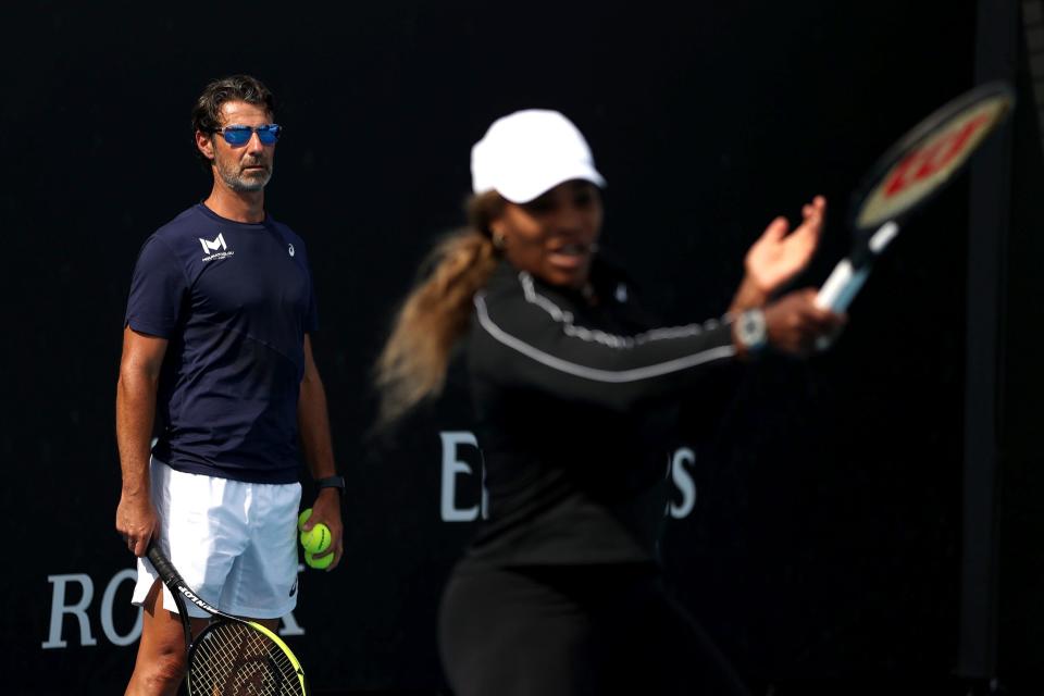 Patrick Mouratglou works with Serena Williams during a practice session.