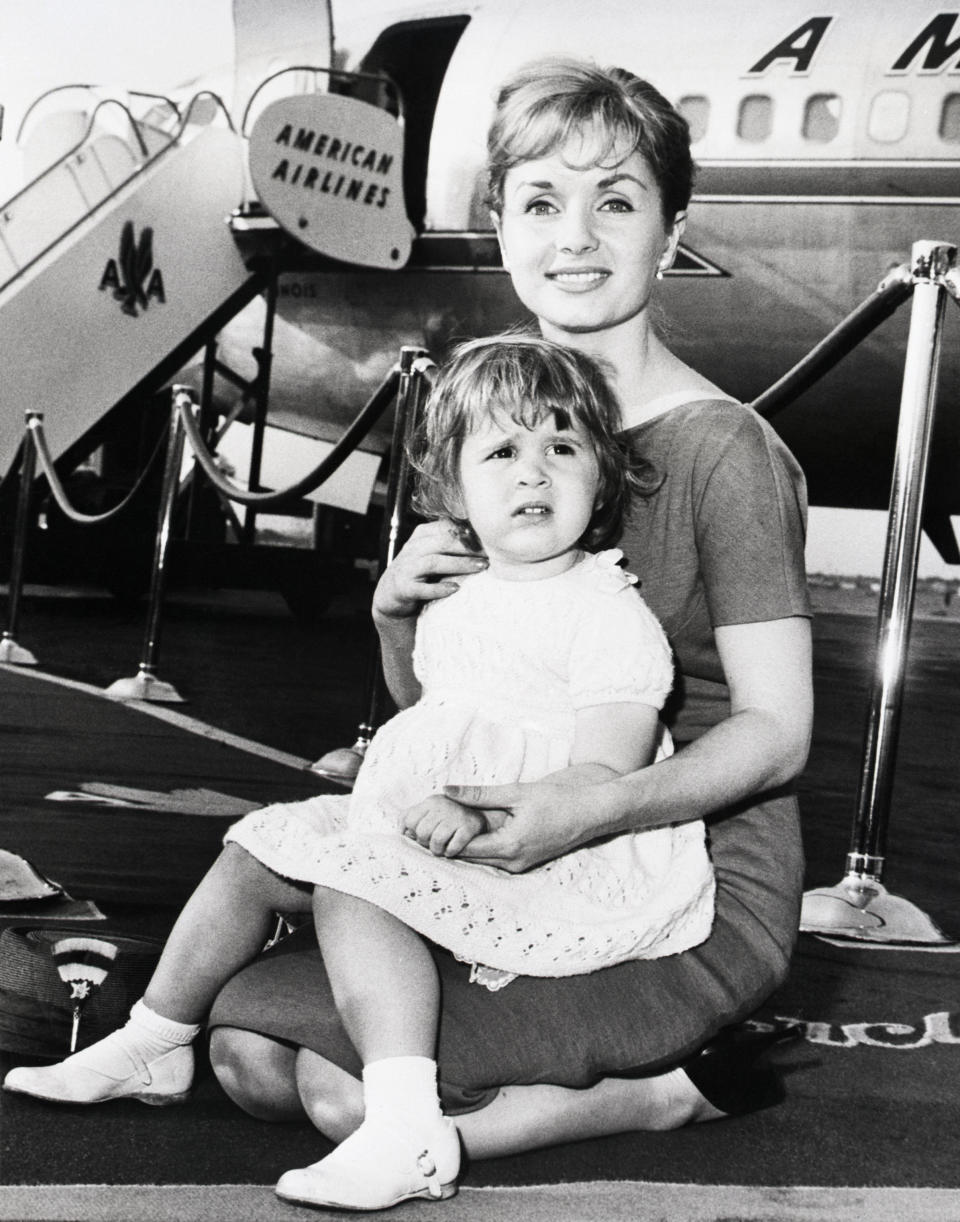 The mother and daughter prepare to board an American Airlines flight at LaGuardia Airport in June 1959.